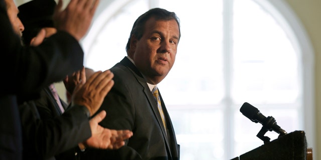 Aug. 25, 2015: New Jersey Gov. Chris Christie listens to applause after he called on Democratic Sen. Cory Booker and the state's congressional delegation to join Sen. Bob Menendez in opposing the Iran nuclear deal at Rutgers University in New Brunswick, N.J. (AP Photo/Mel Evans)