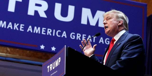 FILE - In this June 16, 2015 file photo, Donald Trump announces he will run for president of the United States, in the lobby of Trump Tower in New York. (AP Photo/Richard Drew, File)