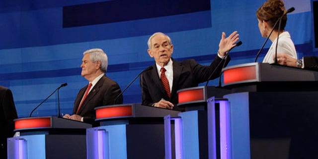 Republican presidential candidates from left, former Massachusetts Gov. Mitt Romney, former House Speaker Newt Gingrich, Rep. Ron Paul, R-Texas, and Rep. Michele Bachmann, R-Minn.,  participate in a Republican presidential debate in Sioux City, Iowa, Thursday, Dec. 15, 2011. (AP Photo/Eric Gay, Pool)