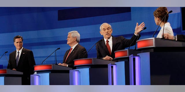 Republican presidential candidates from left, former Massachusetts Gov. Mitt Romney, former House Speaker Newt Gingrich, Rep. Ron Paul, R-Texas, and Rep. Michele Bachmann, R-Minn., participate in a Republican presidential debate in Sioux City, Iowa, Thursday, Dec. 15, 2011. (AP Photo/Eric Gay, Pool)
