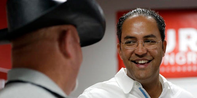 In this Saturday, Aug. 27, 2016 photo, first-term Republican Rep. Will Hurd, right, of Texas, talks with a supporter at a campaign office, in San Antonio. Many House Republican incumbents worry that blowback from Republican presidential nominee Donald Trump's anti-Hispanic rhetoric and promises to build a towering wall the length of the U.S.-Mexico border could hurt their re-election chances, a problem especially acute for those in heavily Latino districts like that of Hurd, whose territory encompasses 820 miles of the U.S.-Mexico border. (AP Photo/Eric Gay)