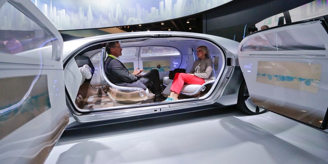 FILE - In this January 2015 file photo, attendees sit in the self-driving Mercedes-Benz F 015 concept car at the Mercedes-Benz booth at the International CES, in Las Vegas. Everything we buy or use these days has the potential to be smarter. Self-driving cars can transform our commuting hours into productive time. Sensor-laden socks can let us know how to jog with fewer injuries. The 2016 International CES will have a panoply of vendors showing off such connected devices, from smart umbrellas that will notify you if youve left them behind, to navigation devices that project directions on car windshields so you dont have to take your eyes off the road. (AP Photo/Jae C. Hong, File)