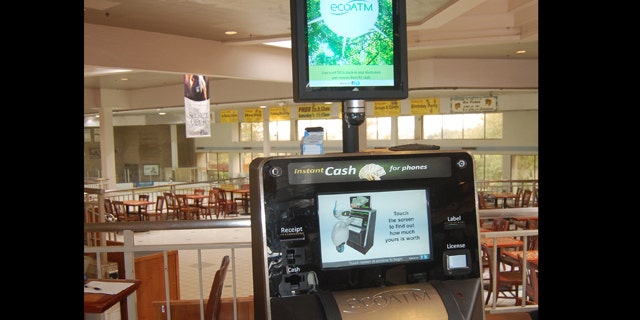 This undated photograph provided by ecoATM, shows the EcoATM, which is a cupboard-sized machine with a big touch screen and a big metal mouth where you can place your old phone or MP3 player. Its analysis complete, it gives you a quote on the spot, based on what a network of hundreds of electronics-recycling companies are willing to pay for it. If you accept, it spits out cash.