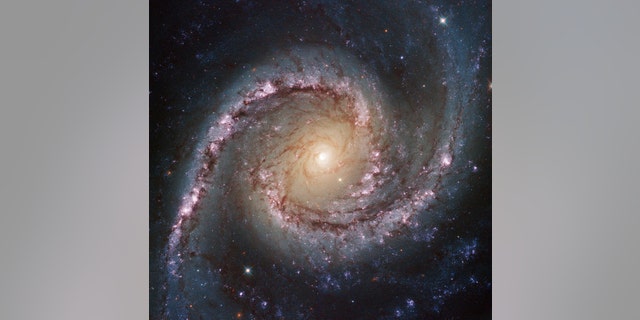 The small but extremely bright nucleus of galaxy NGC 1566 is clearly visible in this Hubble image, a telltale sign of its membership of the Seyfert class of galaxies. The centers of such galaxies are very active and luminous, emitting strong bursts of radiation and potentially harboring supermassive black holes that are many millions of times the mass of the Sun.