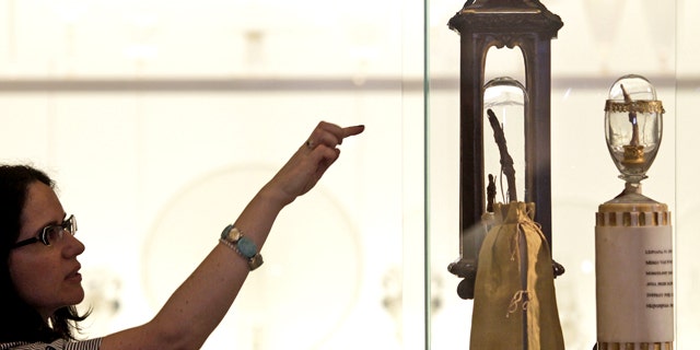 A woman looks at two fingers of Italian 17th century astronomer Galileo Galilei on display at the newly reopened Galileo Museum of Science, in Florence, Tuesday, June 8, 2010.