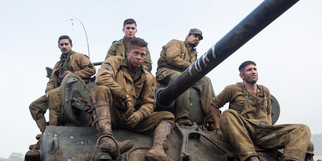 This photo released by Sony Pictures Entertainment shows, from left, Shia LaBeouf as Boyd "Bible" Swan, Logan Lerman as Norman, Brad Pitt as Sgt. Don âWardaddyâ Collier, Michael Pena as Trini "Gordo" Garcia, and Jon Bernthal as Grady "Coon-Ass" Travis, in Columbia Pictures' "Fury." Before the World War II tank drama reaches theaters Oct. 17, gamers can make like Pitt's character and steer a virtual rendition of the M4A3E8 Sherman tank he commands in the film in the game "World of Tanks." It's the latest example of a likeminded movie and game aligning to hype each other, and it marks the first Hollywood pact for the popular online tank combat title. (AP Photo/Sony Pictures Entertainment, Giles Keyte)