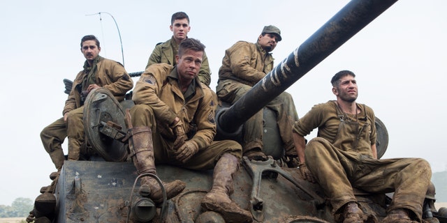 This photo released by Sony Pictures Entertainment shows, from left, Shia LaBeouf as Boyd "Bible" Swan, Logan Lerman as Norman, Brad Pitt as Sgt. Don âWardaddyâ Collier, Michael Pena as Trini "Gordo" Garcia, and Jon Bernthal as Grady "Coon-Ass" Travis, in Columbia Pictures' "Fury." Before the World War II tank drama reaches theaters Oct. 17, gamers can make like Pitt's character and steer a virtual rendition of the M4A3E8 Sherman tank he commands in the film in the game "World of Tanks." It's the latest example of a likeminded movie and game aligning to hype each other, and it marks the first Hollywood pact for the popular online tank combat title. (AP Photo/Sony Pictures Entertainment, Giles Keyte)