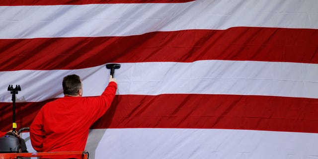 A workman steams a U.S. flag in preparation for a planned visit by President Barack Obama Wednesday, April 6, 2011, at wind turbine manufacture Gamesa Technology Corporation in Fairless Hills, Pa. (AP)