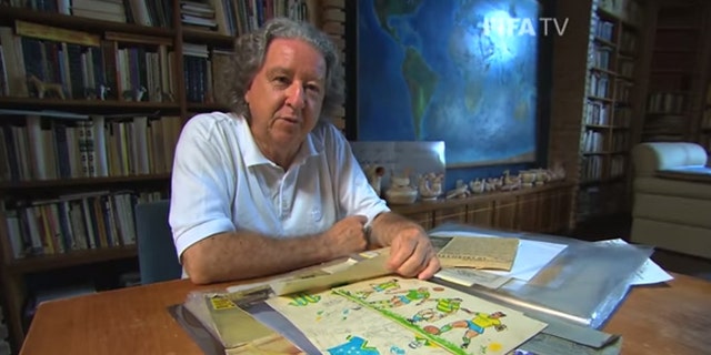 Aldyr García Schlee at home in Brazil with his original uniform designs.