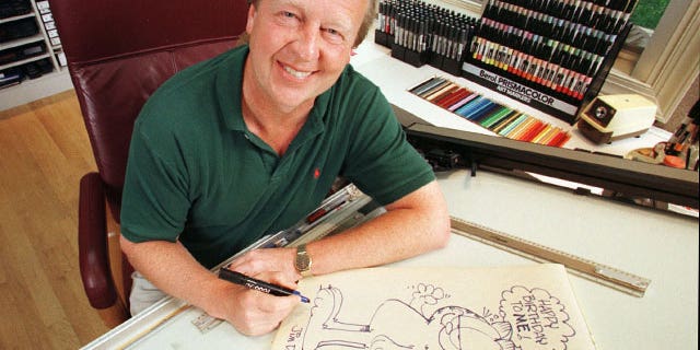 FILE - In this June 9, 1998 file photo, Garfield creator Jim Davis pauses after drawing the cartoon character in his Muncie, Ind., office.