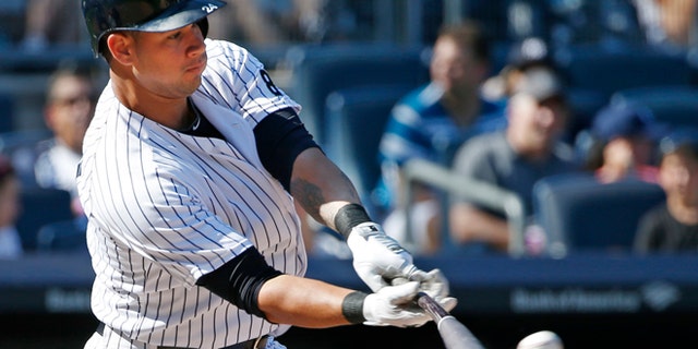 New York Yankees designated hitter Gary Sanchez (24) hits an eighth-inning double in a baseball game against the Baltimore Orioles in New York, Sunday, Aug. 28, 2016. (AP Photo/Kathy Willens)