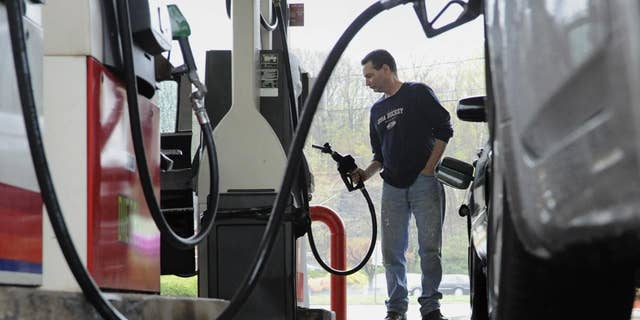 John Magel of Wetherfield pumps gas at a CITGO station in Wethersfield, Conn. (AP Photo/Jessica Hill)