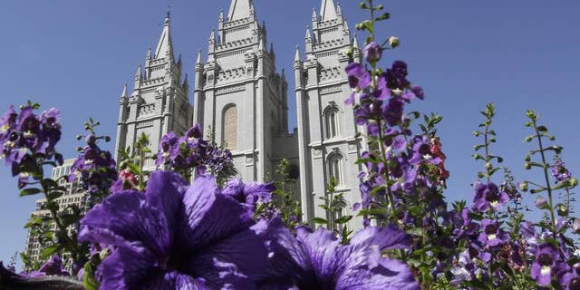 FILE- Sept. 3, 2014: Flowers blooming in front of the Salt Lake Temple in Temple Square, in Salt Lake City. (AP Photo/Rick Bowmer, File)