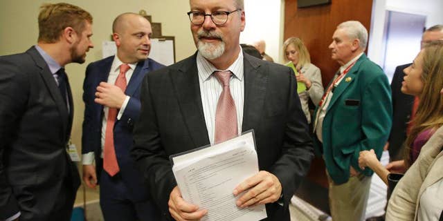 Sen. Stephen Urquhart, R-St. George, leaves a House committee hearing Tuesday, March 10, 2015, in Salt Lake City. An anti-discrimination bill protecting LGBT Utah residents and religious rights awaits a final vote by lawmakers. The bill was approved on Tuesday afternoon. It was originally scheduled for Monday, but postponed by the House Judiciary Committee after an hour-long hearing so that they could hear more comments from the public. (AP Photo/Rick Bowmer)
