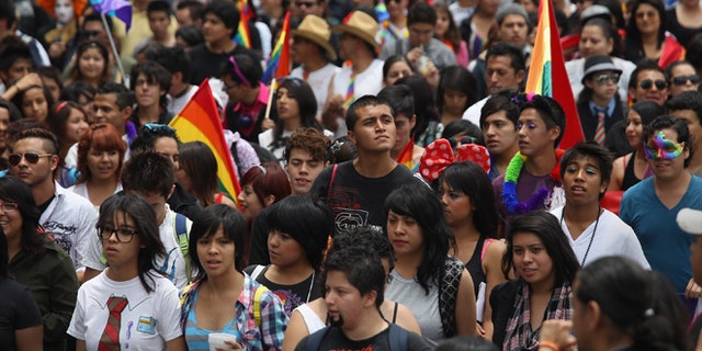MEXICO CITY, MEXICO - JUNE 30:  Thousands of people fill Mexico City's Paseo de la Reforma during a gay pride march on June 30, 2012 in Mexico City, Mexico. Mexicans go the polls Sunday for presidential elections.  (Photo by John Moore/Getty Images)