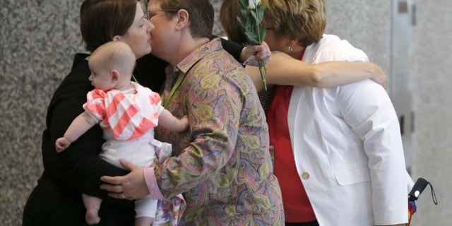 Aug. 26, 2014: Supporters and plaintiffs of gay marriage greet each other after attending a hearing before the 7th U.S. Circuit Court of Appeals on the challenges to Indiana and Wisconsin's gay marriage bans.