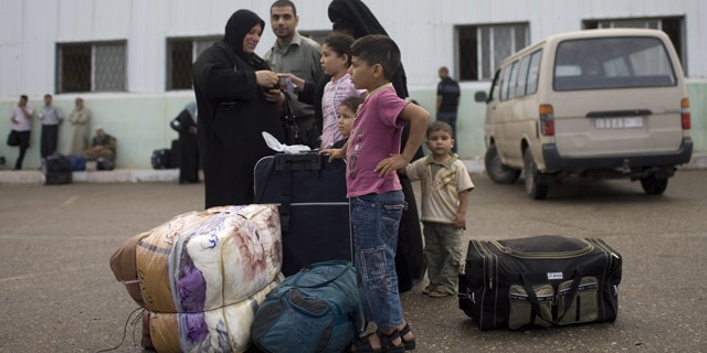 May 28, 2011: A Palestinian family waits before crossing into Egypt through the Rafah border crossing, southern Gaza Strip. After four years, Egypt on Saturday permanently opened the Gaza Strip's main gateway to the outside world, bringing long-awaited relief to the territory's Palestinian population and a significant achievement for the area's ruling Hamas militant group.