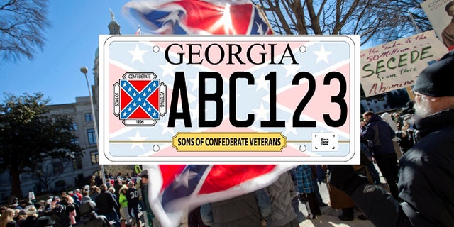 Alan Keck, of Atlanta, right, waves a Confederate flag during the March For Life anti-abortion rally outside the State Capitol, Wednesday, Jan. 22, 2014, in Atlanta. Hundreds of anti-abortion demonstrators gathered outside the Statehouse for the annual rally to protest the Supreme Court's landmark 1973 decision that declared a constitutional right to abortion. (AP Photo/David Goldman)