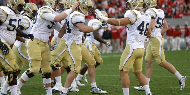 Georgia Tech's Matt Connors, center, is congratulated by teammates following Connors' touchdown against North Carolina State during the second half of an NCAA college football game in Raleigh, N.C., Saturday, Nov. 8, 2014. Georgia Tech won 56-23. (AP Photo/Gerry Broome)