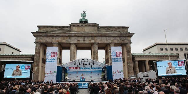 German Chancellor Angela Merkel delivers her speech at a rally against anti-Semitism near the Brandenburg Gate in Berlin, Sunday, Sept. 14, 2014. Thousands of protesters attended the public rally organized by Germany’s Jewish community at the capital’s Brandenburg Gate after tensions over the Gaza conflict spilled over into demonstrations in Europe that saw anti-Jewish slogans and violence. The slogan reads: Stand Up! - Jew hatred - never again!', and the name of the organizer: Central Council of Jews in Germany. (AP Photo/Markus Schreiber)