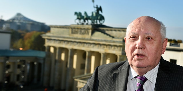 November 8, 2014: Former Soviet Leader Mikhail Gorbachev stands in front of the Brandenburg Gate in Berlin. (AP Photo/dpa, Jens Kalaene)