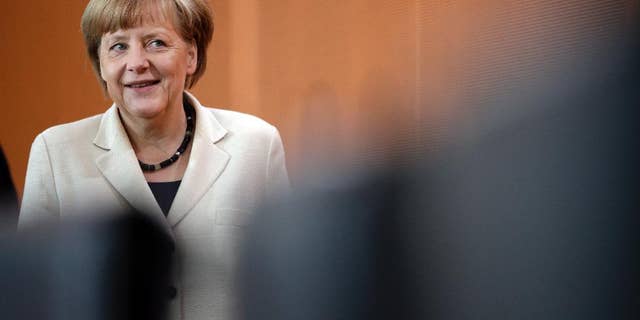 German Chancellor Angela Merkel arrives for the weekly cabinet meeting at the chancellery in Berlin, Germany, Wednesday, May 21, 2014. (AP Photo/Michael Sohn)