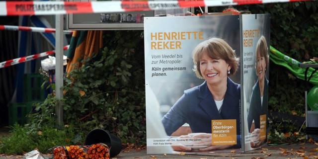 Oct. 17, 2015: Election posters of independent candidate for the mayor of Cologne Henriette Reker stand behind a police barrier in Cologne, Germany. Reker was wounded in a stabbing at this site as she campaigned on Saturday, a day before an election in the western German city. (Oliver Berg/dpa via AP)