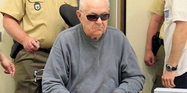 June 8 file photo showing accused Nazi death camp guard John Demjanjuk as he arrives in a courtroom in Munich.