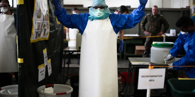 Oct. 23, 2014: A volunteer of the German forces Bundeswehr gets sprayed a bleach mixture on his protective suit during a training for the Ebola virus in Appen about 15.5 miles north of Hamburg, Germany.