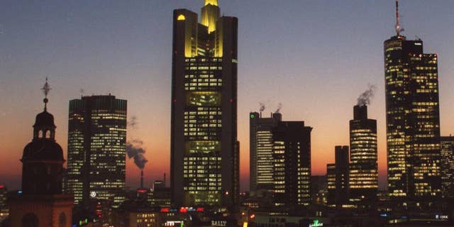 FILE- In this file photo dated Feb. 2000, showing the banking district in downtown Frankfurt, Germany, with buildings from left: Church St. Catherine, European Central Bank, Commerzbank Headquarters, Dresdner Bank, Japan Tower, Citibank, Main Tower.  On Tuesday Dec. 2, 2014, the issue of looming deflation seems the main factor driving European policymakers when they meet later this week and forcing speculation that the ECB will switch on the printing press to help the economy by injecting new money into the economy. (AP Photo/Bernd Kammerer, FILE)