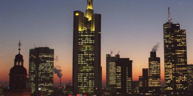 FILE- In this file photo dated Feb. 2000, showing the banking district in downtown Frankfurt, Germany, with buildings from left: Church St. Catherine, European Central Bank, Commerzbank Headquarters, Dresdner Bank, Japan Tower, Citibank, Main Tower. On Tuesday Dec. 2, 2014, the issue of looming deflation seems the main factor driving European policymakers when they meet later this week and forcing speculation that the ECB will switch on the printing press to help the economy by injecting new money into the economy. (AP Photo/Bernd Kammerer, FILE)