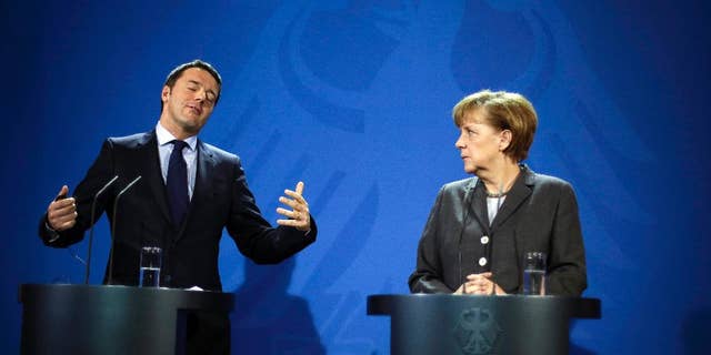 German Chancellor Angela Merkel, right and Italian Prime Minister Matteo Renzi brief the media, after German and Italian government consultations at the chancellery in Berlin, Monday, March 17, 2014. (AP Photo/Markus Schreiber)