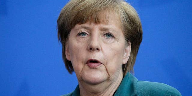 German Chancellor Angela Merkel addresses the media during a joint press conference with Prime Minister of Japan Shinzo Abe, as part of a meeting at the chancellery in Berlin, Germany, Wednesday, April 30, 2014. (AP Photo/Michael Sohn)