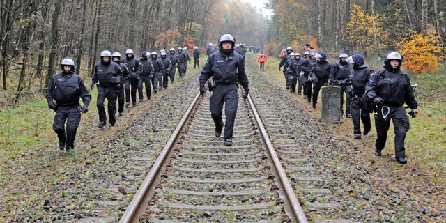 Nov. 7, 2011: Police officers secure the rails near Leitstade, Germany, prior to a nuclear waste transport passing through the area. German police are preparing a big security operation to protect a shipment of nuclear waste being moved to storage site next week, as protests are expected despite a decision to speed up the country's exit from nuclear energy.