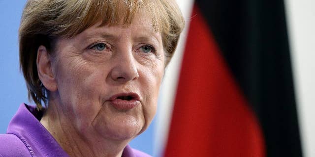 German Chancellor Angela Merkel addresses the media during a joint press conference as part of a meeting with the Prime Minister of Poland, Ewa Kopacz, at the chancellery in Berlin, Germany, Thursday, Oct. 9, 2014. (AP Photo/Michael Sohn)