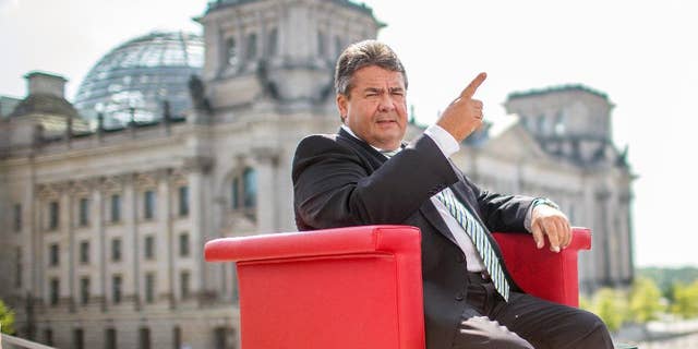 German vice chancellor and Minister for Economy, Sigmar Gabriel attends an interview by German TV channel ARD in Berlin, Sunday July 27, 2014. In background the parliament building 'Reichstag' . Germany’s vice chancellor says Europe should take aim at rich businesspeople who support Russia’s government as it increases pressure on Moscow over its actions in Ukraine. Sigmar Gabriel, who is also Germany’s economy minister, told ARD television Sunday that measures should target “those on whose shoulders the Russian government stands: the oligarchs, the billionaires.” (AP Photo/dpa/Hannibal Hanschke)