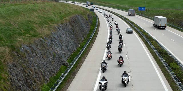 Members of the Russian motorcycle club 'Night wolves' as well as supporters ride their motorbikes along a motorway near Breitenau, Germany, May 7,2015. They are expected to arrive in Berlin on May 9, as part of their tour from Moscow to the German capital. Russia will celebrate the anniversary of the Soviet Union's World War II victory over Nazi Germany on the same day. ( Arno Burgi/dpa via AP)
