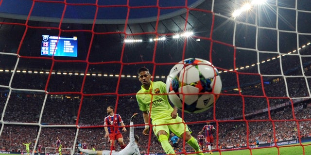 Barcelona's Neymar scores his side's opening goal during a Champions League semi final second leg soccer match between Bayern Munich and FC Barcelona in Munich, Germany, Tuesday, May 12, 2015. (Tobias Hase /dpa via AP)