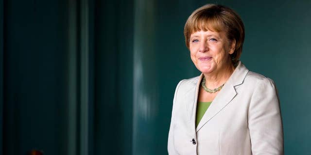 German Chancellor Angela Merkel waits for the arrival of the participants at the 'West Balkan Conference' at the chancellery in Berlin, Thursday, Aug. 28, 2014. Merkel invited to the conference to support the economic and political situation in the South-East European region. (AP Photo/Markus Schreiber, Pool)