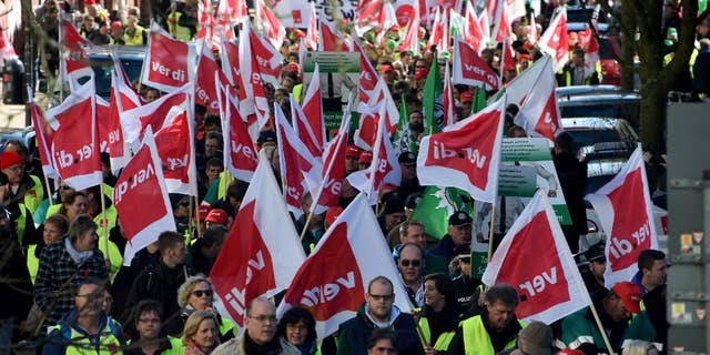 German public service workers join al rally in a bid to receive higher wages and preserve pension benefits in Kiel, northern Germany, Wednesday, March 11, 2015. The ver.di union said teachers and other public employees including police and firefighters walked off the job in multiple states in Germany. (AP Photo/dpa, Carsten Rehder)