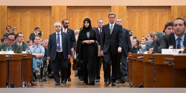 The President of the Syrian National Council Abdulbaset Sieda, Minister of State of the United Arab Emirates Reem al-Hashimi and German Foreign Minister Guido Westerwelle, front from left, arrive at a gathering of Syrian opposition representatives and diplomats hosted at the Germany foreign ministry in Berlin, Tuesday, Sept. 4, 2012. Germany's foreign minister is pressing disparate Syrian opposition groups to unite in preparation for the collapse of the Bashar Assad regime. Berlin hosted a gathering of Syrian opposition representatives and diplomats Tuesday to address how to prevent basic services and infrastructure collapsing, and how to revive the economy, once Assad falls. (AP Photo/Markus Schreiber)