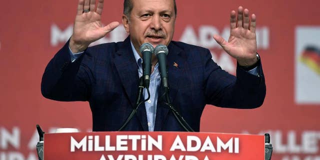 Turkish President Recep Tayyip Erdogan delivers a speech in an exhibition hall in Karlsruhe, Germany, Sunday, May 10, 2015. Erdogan has urged compatriots during his appearance to preserve their homeland’s values and language and to vote ahead of upcoming Turkish elections. (Ulli Deck/dpa via AP)