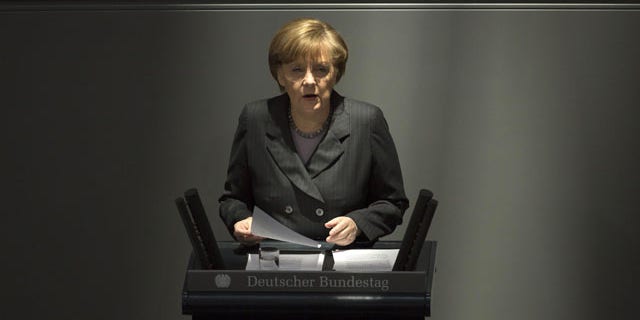 March 13, 2014: German Chancellor Angela Merkel delivers a speech on the Ukrainian crisis at the parliament Bundestag in Berlin, in which she warned Moscow that if it continues its current course in the Ukraine crisis, Russia risks “massive” political and economic consequences. (AP Photo/Markus Schreiber)
