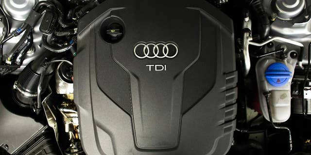 The sign of German car company Audi is attached on the engine of a TDI, a turbo diesel model, in Berlin, Germany, Monday, Sept. 28, 2015. Volkswagen AG's upmarket Audi brand said 2.1 million of its vehicles are among those with the engines affected by the emissions-rigging scandal. (AP Photo/Markus Schreiber)