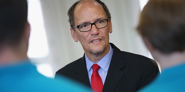 BERLIN, GERMANY - OCTOBER 28: U.S. Labor Secretary Thomas Perez chats with trainees at the Siemens training facility on October 28, 2014 in Berlin, Germany. Secretary Perez visited the center to learn more about the German trainee system, in which manufacturers offer paid multi-year training programs to recent high school graduates. U.S. President Obama has expressed interest in adopting the system in the U.S., where thus far training is usually conducted at technical or community colleges, as a way enhance job growth, meet the job requirements of U.S. industry and make the U.S. economy more competitive. (Photo by Sean Gallup/Getty Images)