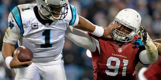 CHARLOTTE, NC - JANUARY 24: Cam Newton #1 of the Carolina Panthers stiff arms Ed Stinson #91 of the Arizona Cardinals in the second half during the NFC Championship Game at Bank of America Stadium on January 24, 2016 in Charlotte, North Carolina. (Photo by Grant Halverson/Getty Images)