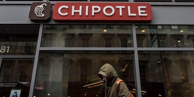 NEW YORK, NEW YORK -- FEBRUARY 8: A man walks past an empty Chipotle restaurant on Broadway in Lower Manhattan on February 8, 2016 in New York City. The Mexican food chain is closing stores for lunch nationwide for a meeting on food safety following a number of E. coli outbreaks. (Photo by Andrew Renneisen/Getty Images)