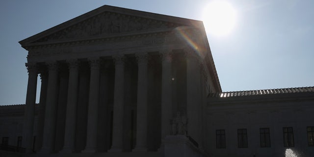 WASHINGTON, DC - MAY 16:  The early morning sun rises behind the U.S. Supreme Court building May 15, 2016 in Washington, DC. Today the high court sent the Affordable Care Act's contraceptive mandate case back down to the lower courts for opposing parties to work out a compromise.  (Photo by Mark Wilson/Getty Images)