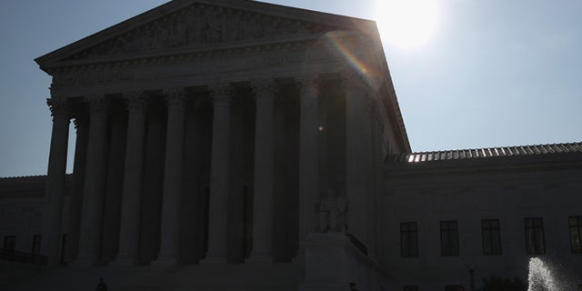 WASHINGTON, DC - MAY 16: The early morning sun rises behind the U.S. Supreme Court building May 15, 2016 in Washington, DC. Today the high court sent the Affordable Care Act's contraceptive mandate case back down to the lower courts for opposing parties to work out a compromise. (Photo by Mark Wilson/Getty Images)