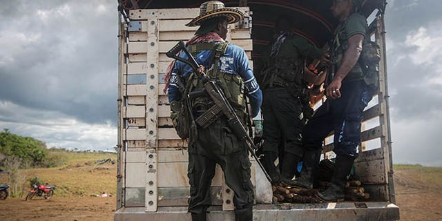 EL DIAMANTE, COLOMBIA - SEPTEMBER 24: Revolutionary Armed Forces of Colombia (FARC) rebels depart their camp following the 10th Guerrilla Conference in the remote Yari plains where the peace accord was ratified by the FARC on September 24, 2016 in El Diamante, Colombia. The peace agreement attempts to end the 52-year-old guerrilla war between the FARC and the state, the longest-running armed conflict in the Americas which has left 220,000 dead. The final agreement is set to be signed on September 26 and will then be put to vote by the public in a referendum on October 2. The plan calls for a disarmament and re-integration of most of the estimated 7,000 FARC fighters. (Photo by Mario Tama/Getty Images)